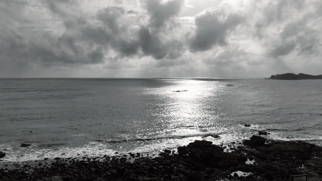 Scenic coastal view under a clear clouded sky