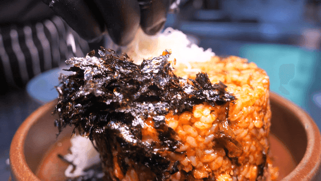 Kimchi fried rice topped with plenty of seaweed and cheese