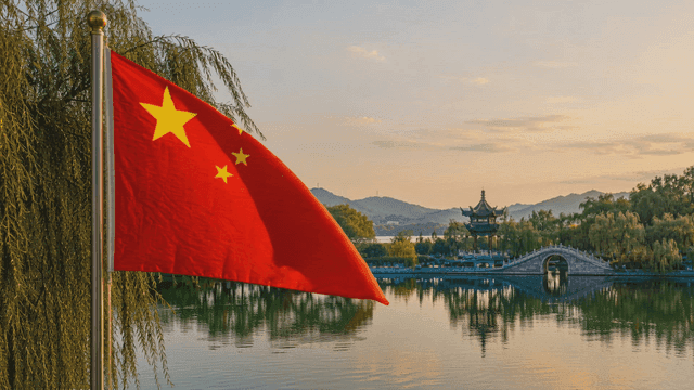 Chinese flag fluttering beside calm lake