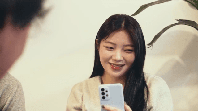 Woman making various facial expressions while looking at her smartphone