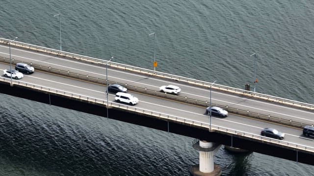 Cars and motorcycles on a bridge