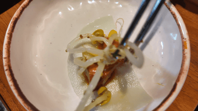 Chopsticks for placing bean sprouts and chicken on radish salad