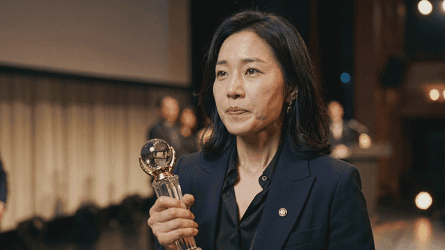 Woman holding trophy on stage