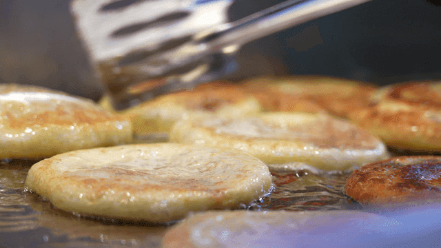Hotteok fried on hot iron plate