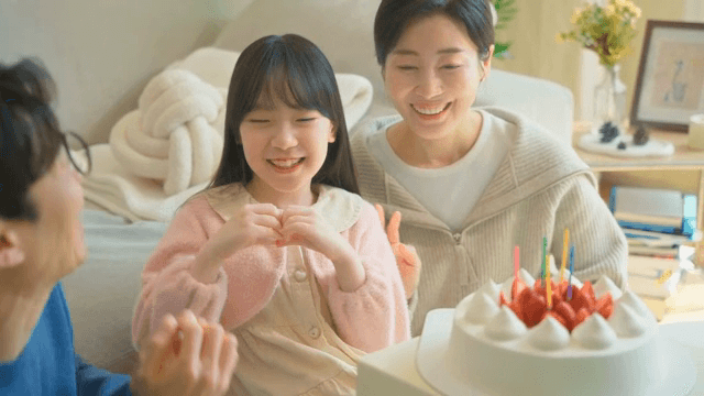 Family celebrating a birthday with cake