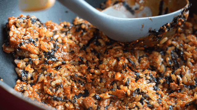 Fried rice being stirred in a pan