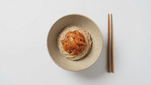 Bowl of bibim guksu with spicy sauce
