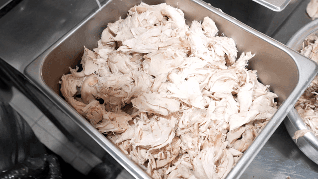 Shredded chicken being prepared in a kitchen