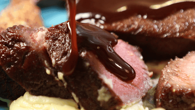 Juicy steak with sauce being poured