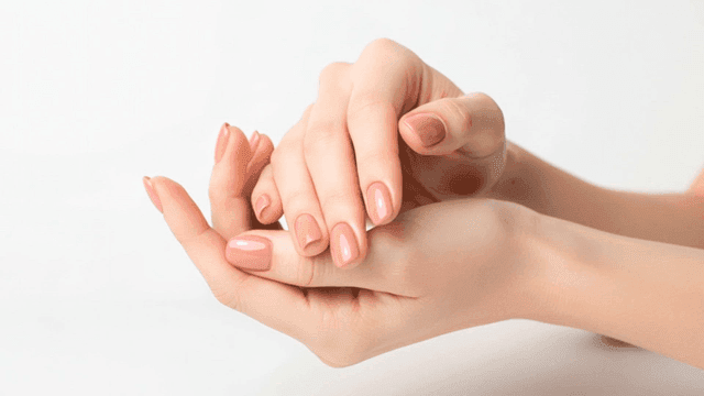 Hands with pink manicured nails