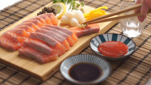 Scene where you put wasabi on salmon sashimi, dip it in soy sauce, and then eat pickled radish