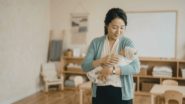 Woman gently holding baby