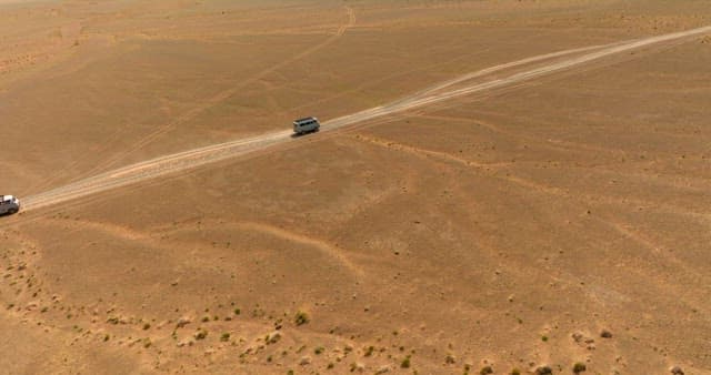 Vehicles driving on a desert road