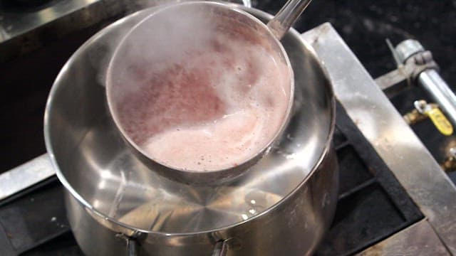 Red bean soup boiling in a pot in the kitchen