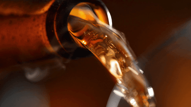 Beer pouring out of bottle