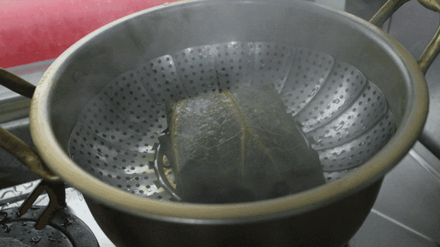 Lotus leaf rice steamed in pot with opening lid