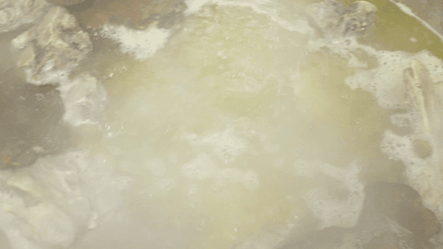 Boiling broth with meat and spices