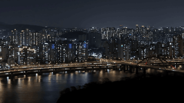 Night view of a bustling city with a bridge