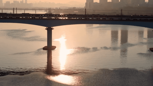 Train crossing a bridge at sunset