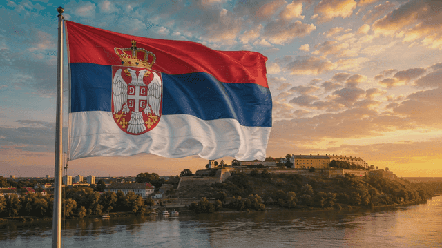 Serbian flag waving over a historic fortress