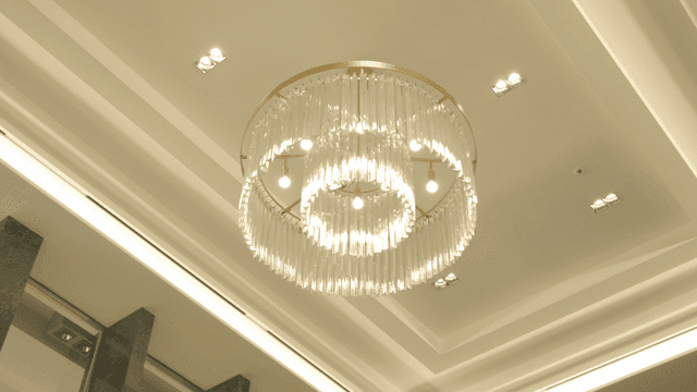 Elegant chandelier on modern ceiling