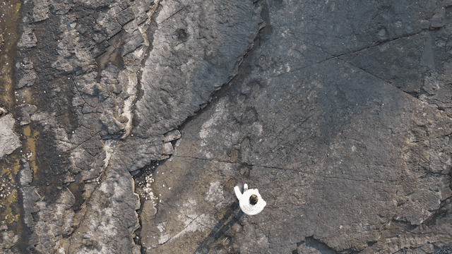 Woman walking on rock surface