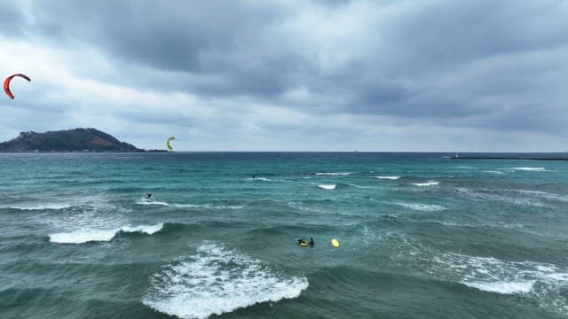 Kite surfers on a windy ocean day