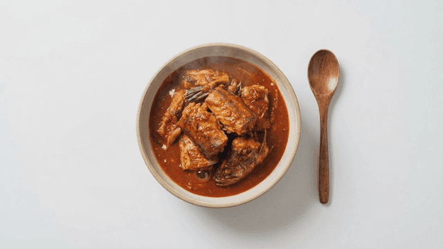 Spoon and bowl of spicy braised mackerel