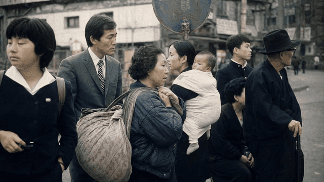 People waiting at street corner bus stop in 70s