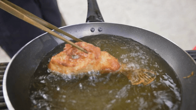 Golden fried fish in hot oil