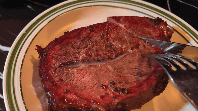 Juicy steak slicing on plate