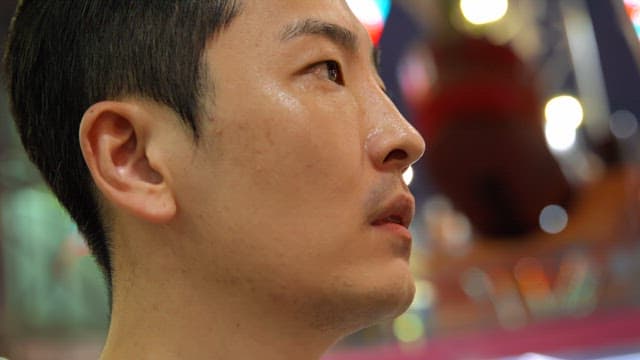 Man looking around at an amusement park