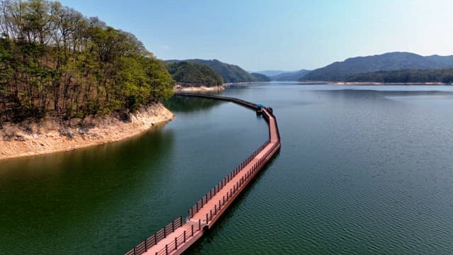 Serene lake with a winding boardwalk