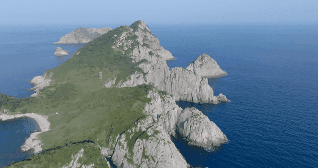 A scenic island surrounded by blue sea