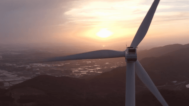Wind turbines in a mountainous area with the setting sun