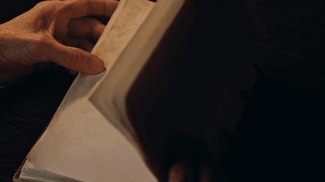 손으로 필기된 노트를 넘기는 장면