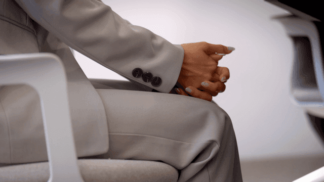 Person in a suit sitting in an office chair