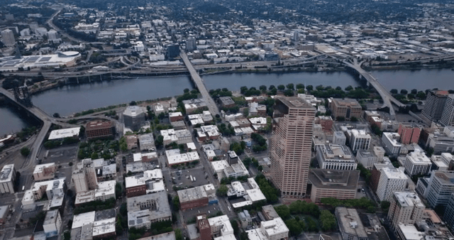 Aerial view of a city with a river and bridge