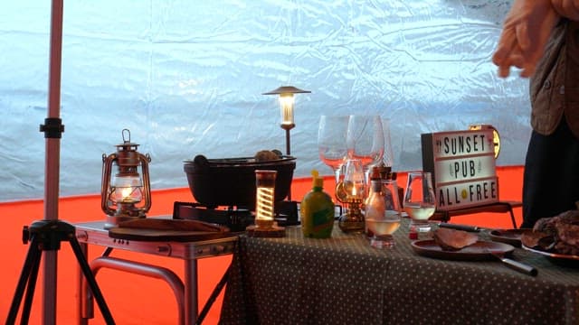 Inside a cozy tent with a table set for dinner