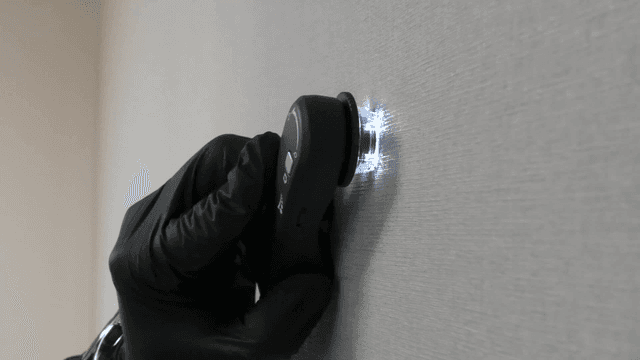 Device scanning a wall with LED lights