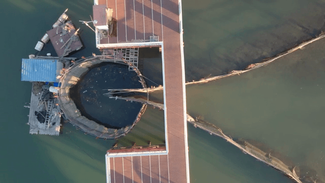 Aerial view of a fish farm on a calm sea