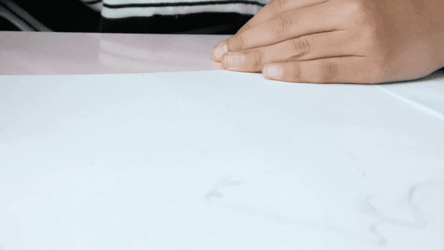 Elementary school student drawing on paper with concentration