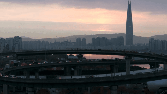 Highway and city skyline at sunset
