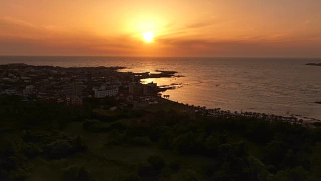 Sunset over a coastal town and ocean