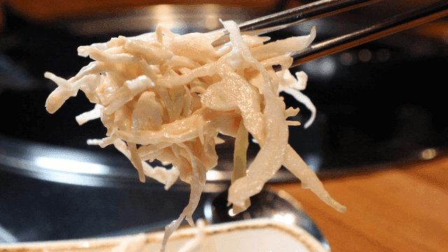 Chopsticks for picking up creamy mayonnaise salad