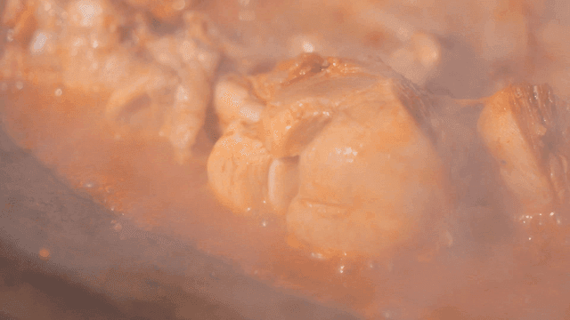 Spicy braised chicken simmering in rich sauce