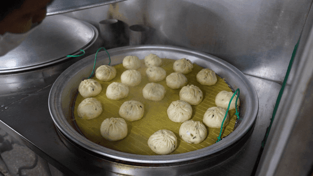 Steamed dumplings in a metal steamer