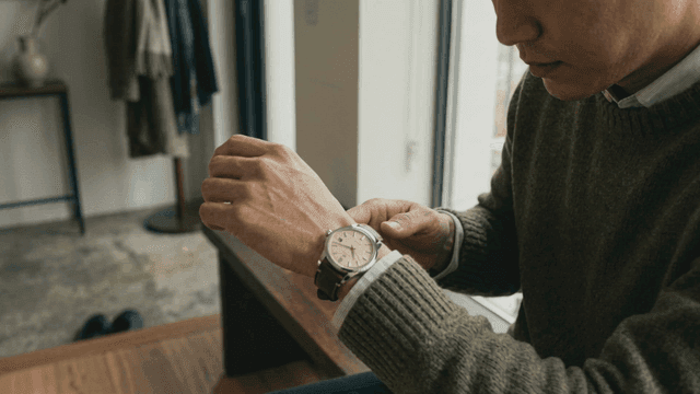 Man adjusting wristwatch