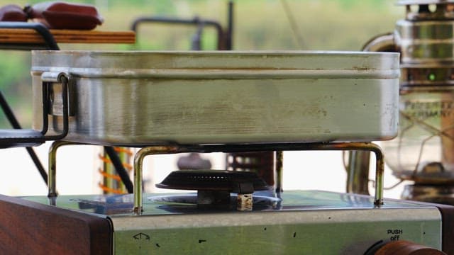 Cooking outdoors with a gas stove and metal pan