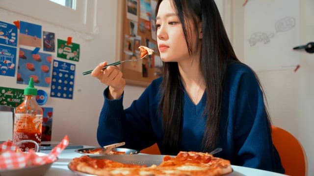 Young woman enjoying pizza indoors